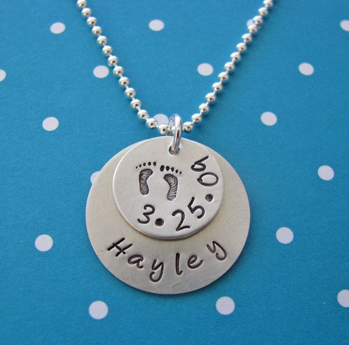 custom hand stamped silver baby name and birthdate necklace with footprints