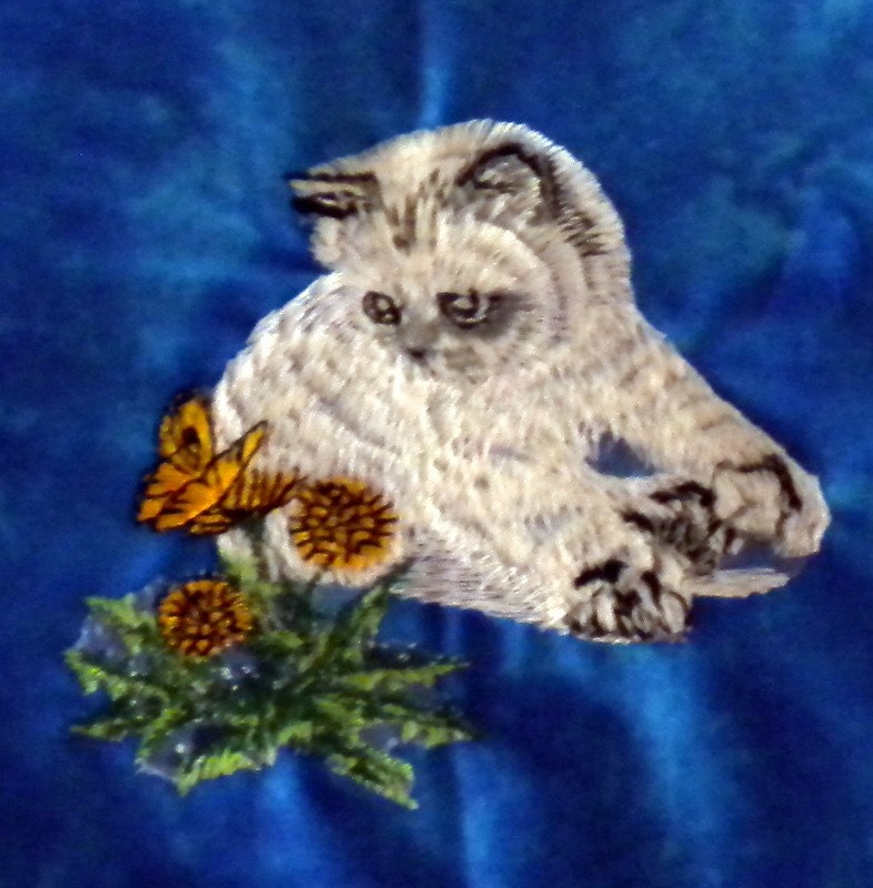 Embroidered Kitten on a decorative plush blue pillow