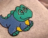 Fleece backed blanket throw with dinosaur embroidery