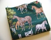 tan, brown and white horses on hunter green novelty print cotton fabric