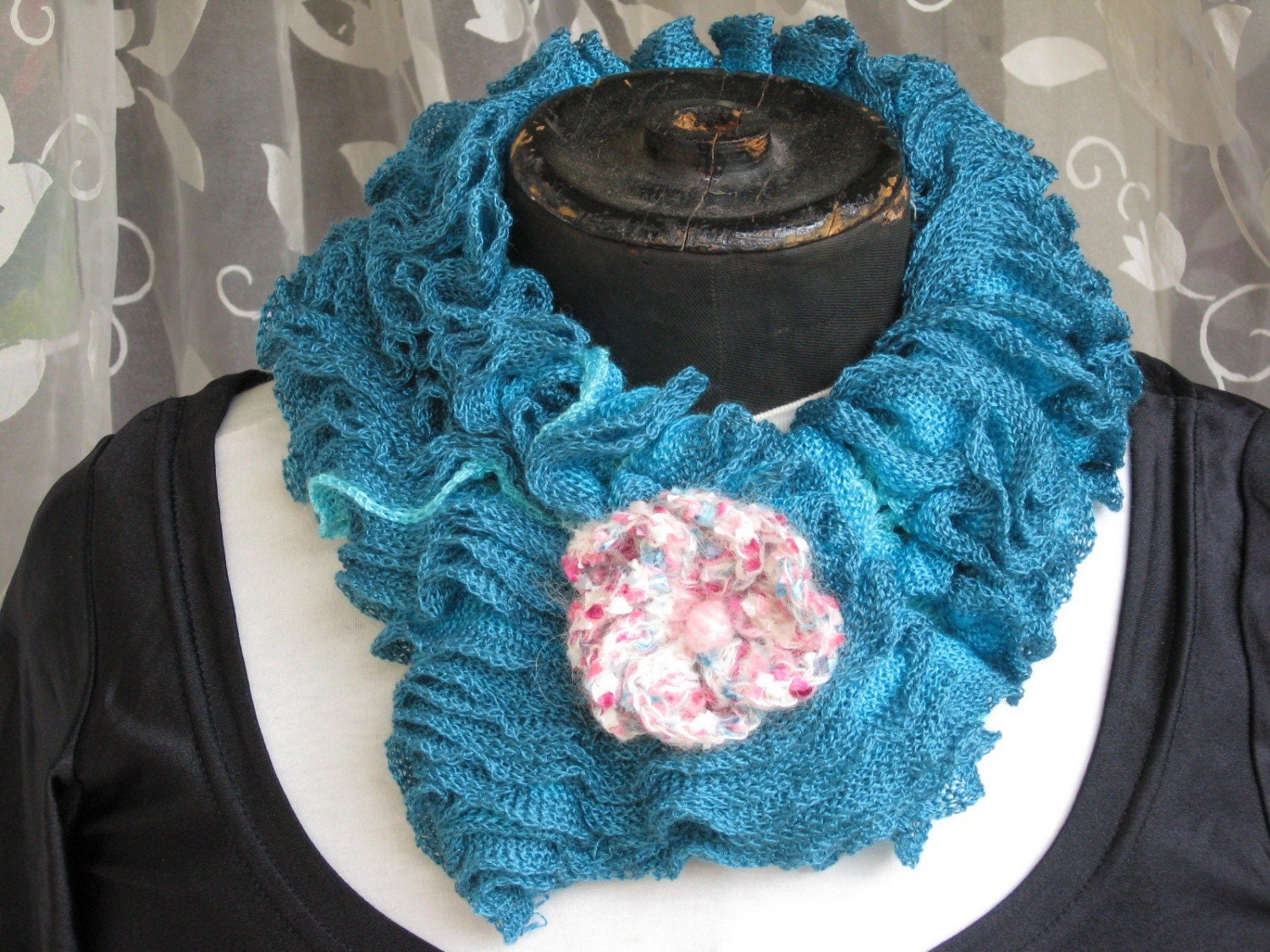 Two-sided turquoise ruffles neckwarmer with knitted flower