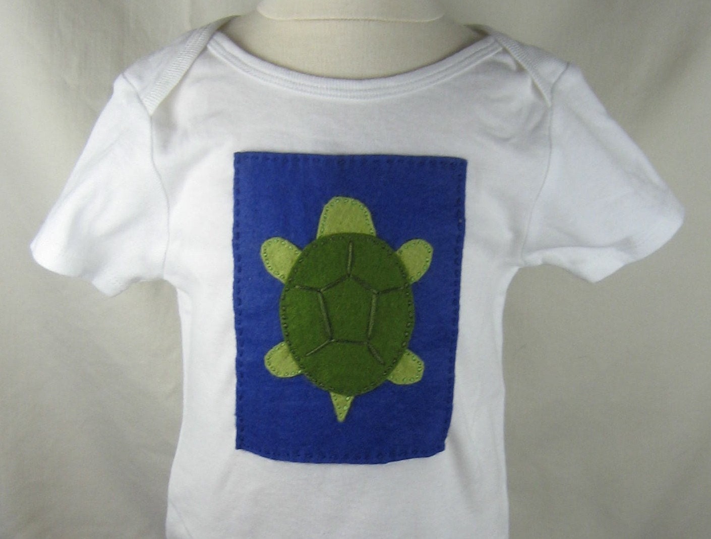 Turtle on Blue Background on 9-12 mo. One Piece
