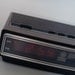 Vintage 1970s General Electric alarm clock with red digital numbers and woodgrain exterior