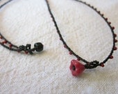 Daintiest crocheted beaded necklace in red and black with tiny red flower charm pendant