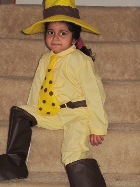 man in yellow hat costume curious george