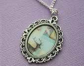 The Deer and The Dancer Pendant Necklace in Fancy Silver Tone Bezel