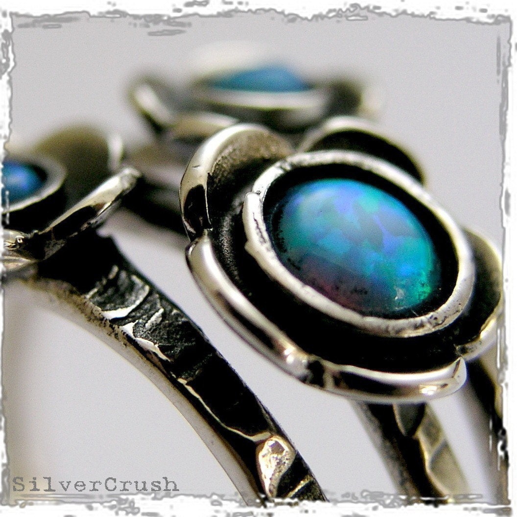 Guess - organic shaped silver ring with opals .
