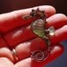 Tiny OLIVE seahorse wire wrapped seaglass pendant.