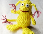 Whimsical monster, crocheted in bright lemon yellow with dusty rose tassels on ears and tail, 5 inches tall