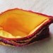 Zippered pouch crocheted in sunset stripes from colorful eco-friendly upcycled yarn, 7.5" by 5.5", red orange yellow pink coral