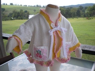 SWIRLY SWEATER With Raspberry pockets and ruffle edge