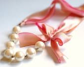 The Original Carrie Necklace in Peace A romantic ribbon and pearl bridesmaid necklace in peach, coral, yellow