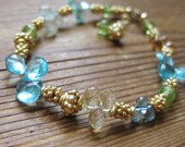 Bracelet of blue apatite, aquamarine, peridot & citrine with gold vermeil daisies by katecojewelry