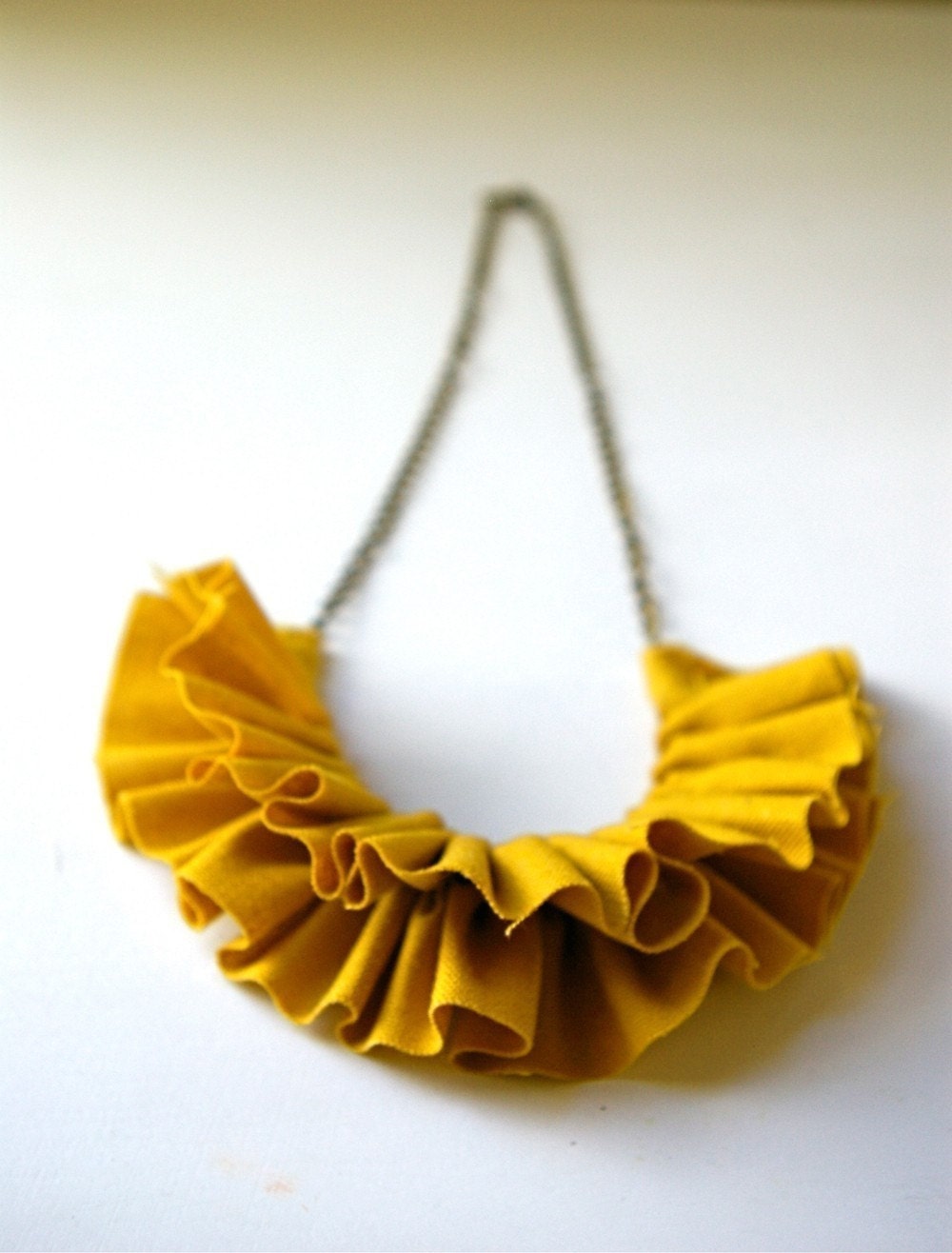 linen ruffle necklace in mustard yellow. antique bronze chain.
