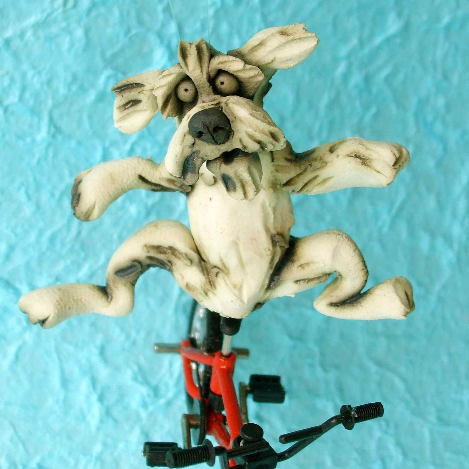 Dog Riding a Bicycle Sculpture