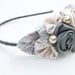 headband of rolled gray and pink roses