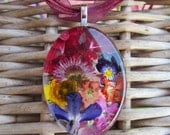 Rainbow of colorful pressed flowers and blooms.  Oval glass 1 x 1.5 inch approx.