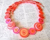 Long pink button necklace.
