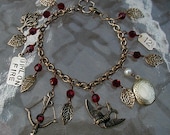 The HUNGER GAMES-  Girl on Fire Hand Stamped Charm Bracelet with Fire Red Crystals and Peeta's Pearl