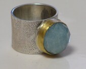 Silver ring with aquamarine stone enveloped with a 22 Karat Gold