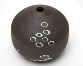 Small slip trail decorated black mountain clay vase with green circle pattern