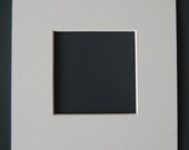 TWELVE:  11 x 14 in. acid free white mats with custom cut opening