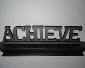 Huge wooden word that says achieve