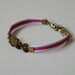 Bracelet Antique gold-plated brass charms and purple ribbon