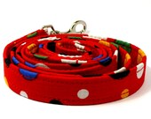 Colorful polka-dotted and red dog leash