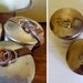 vintage enamelware canisters, 3 small tins with leather straps, white with gold striping from Germany