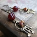 The key keeper - glass beads and brass charm earrings