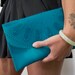 Turquoise lace pattern clutch bag in rubber.