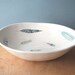 large porcelain bowl with feathers