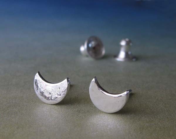 Artisan handmade minimalist  tiny crescent moon post earrings.  Textured shiny reflective studs.  Simple sterling silver jewelry for women.