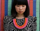 The Clemence woven rope necklace in orange and pink
