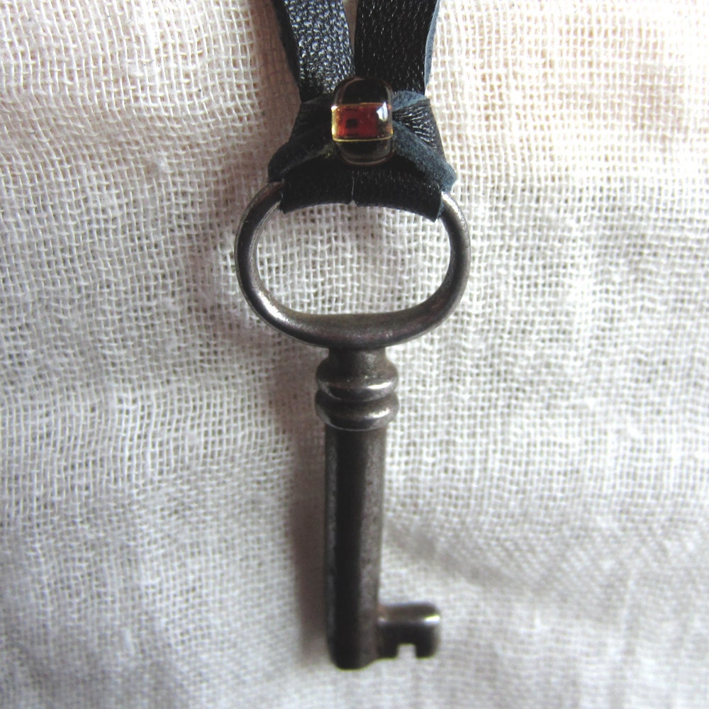 Worn antique skeleton key necklace. Black leather ties / adjustable length. Simple and unisex. Steampunk design