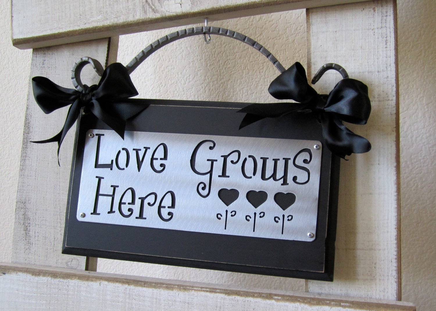 Love Grows Here  Metal on Wood Wall Plaque