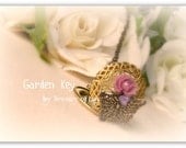Garden Key Necklace made with locket, butterfly, flowers, key etc.