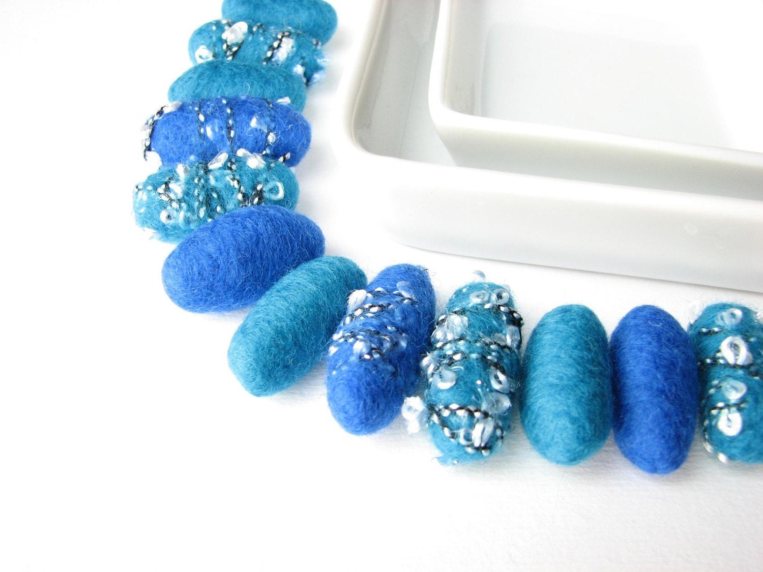 12 felted wool pebbles / beads plain  and decorated with yarn (sapphire blue, teal)