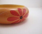 Vintage toffee bangle bracelet. Fiery red daisy. Black polka dots. White swirls. Peach. Tan. Brown. Women's jewelry.