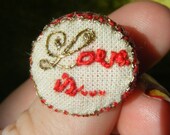 Hand embroidered  art piece 'Love is' ring