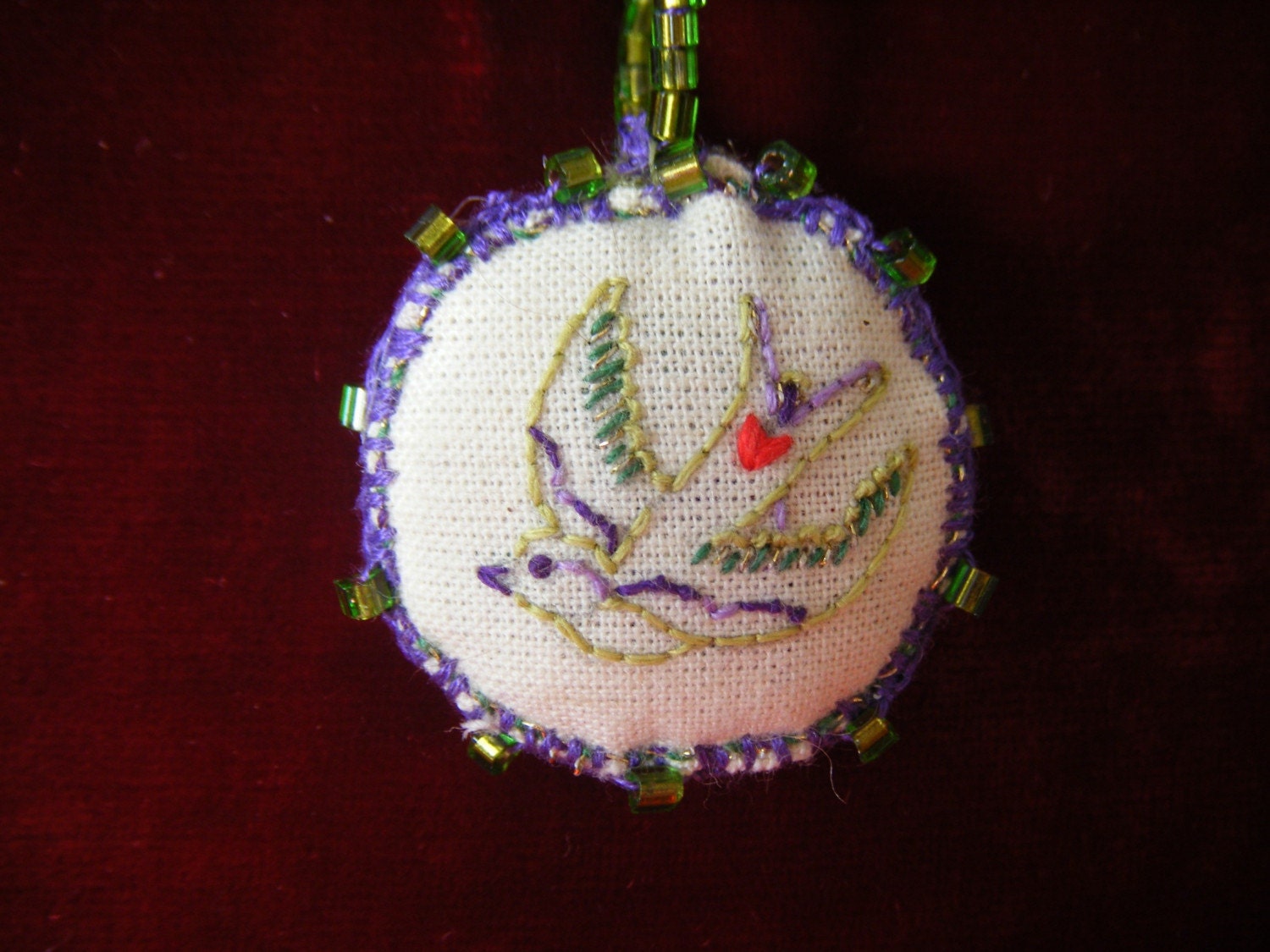 Hand embroidered pendant swallow