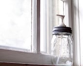 Mason Jar Soap Dispenser made from a clear Ball pint with a zinc repro pump lid