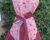 Handmade apron patterned with oven mitts in pink with pink and black checks