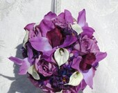 Purple orchids, rosebuds, and delphinium along with pearl studded ivory calla lilies make up "Purple Splendor" kissing ball.