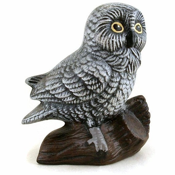 Gray Ceramic Owl Perched On a Log