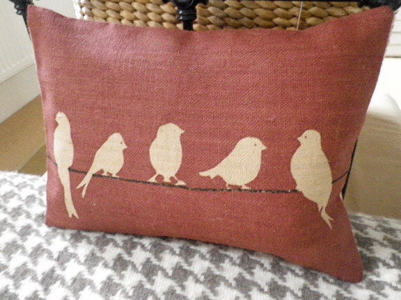 new hand printed  muted red bird on a wire cushion