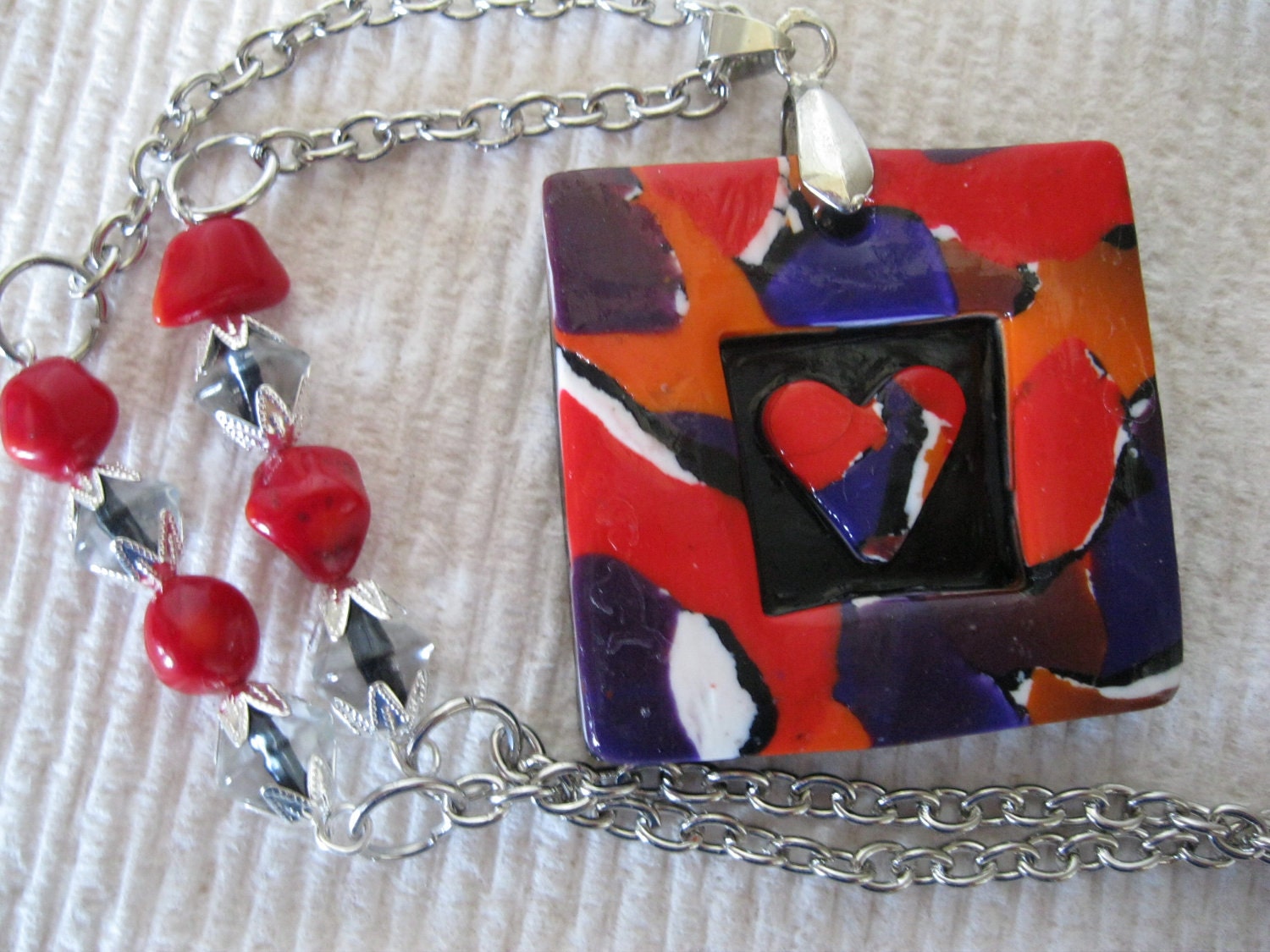 Chunky Polymer Clay 3-D Heart Pendant in red, black, orange and purple on silver chain with coral beads
