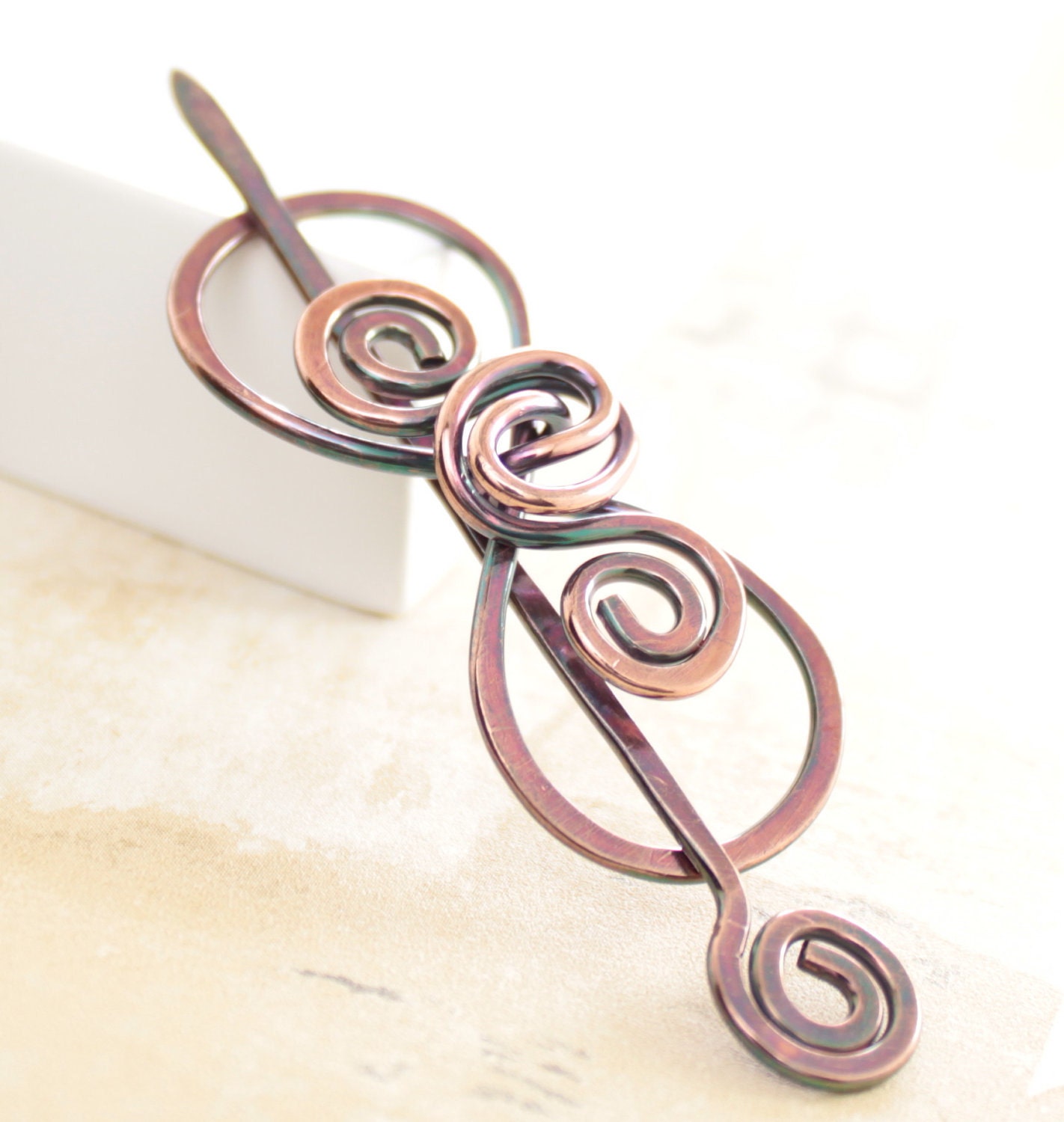 Shawl pin, scarf pin in a swirly bow shape pin with a pin stick