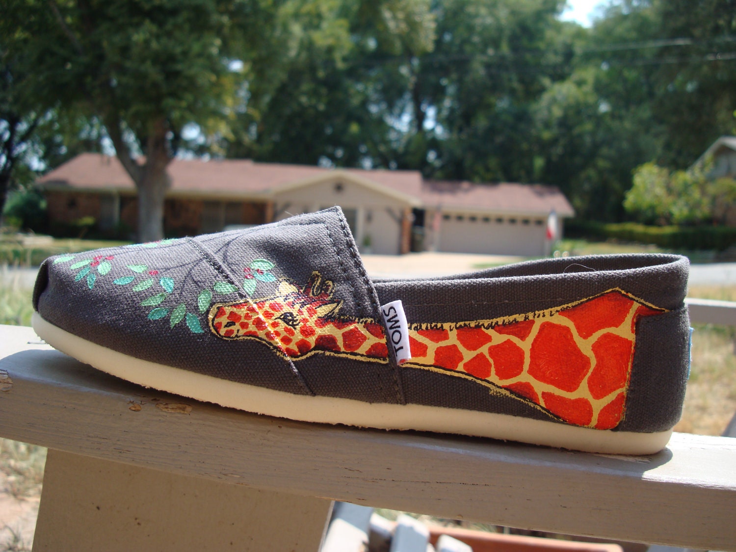 giraffes painted on TOMS shoes
